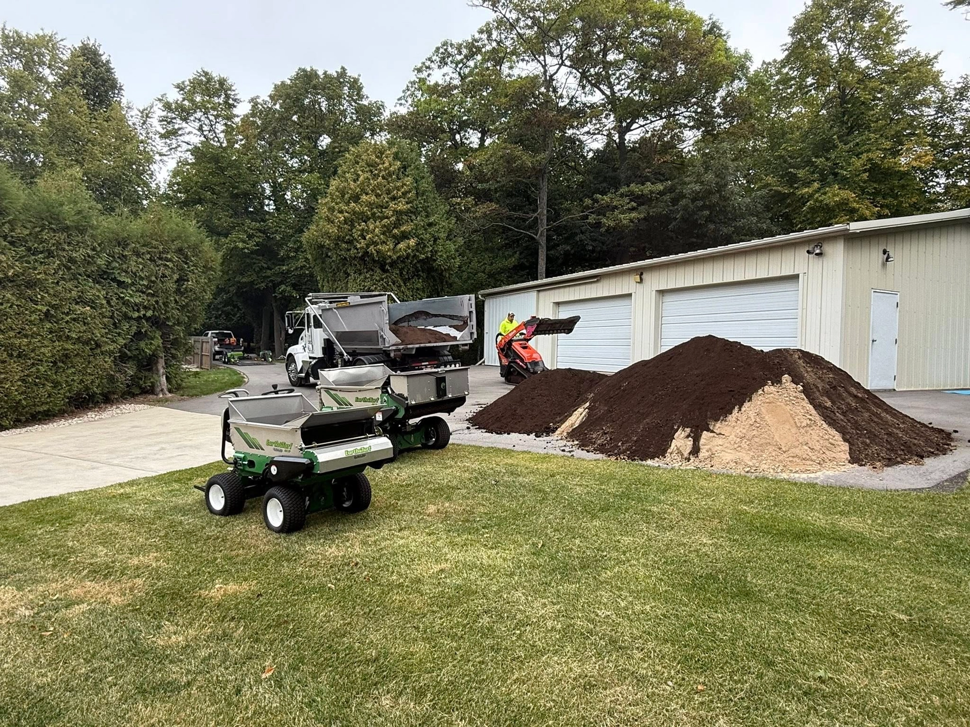 Top dressing machine spreading organic compost on lawn