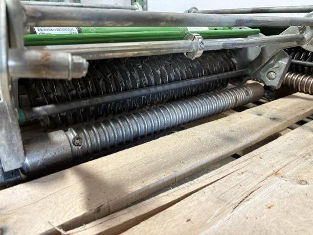 Close-up of Crappy Lawn Care verticutter blades that cut through matted thatch down to bare soil